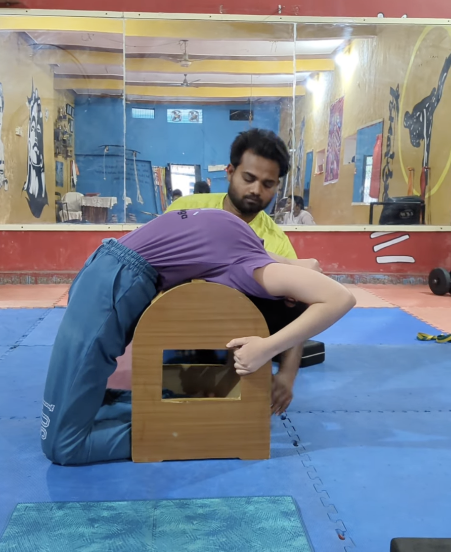 Guided backbend over a yoga arch