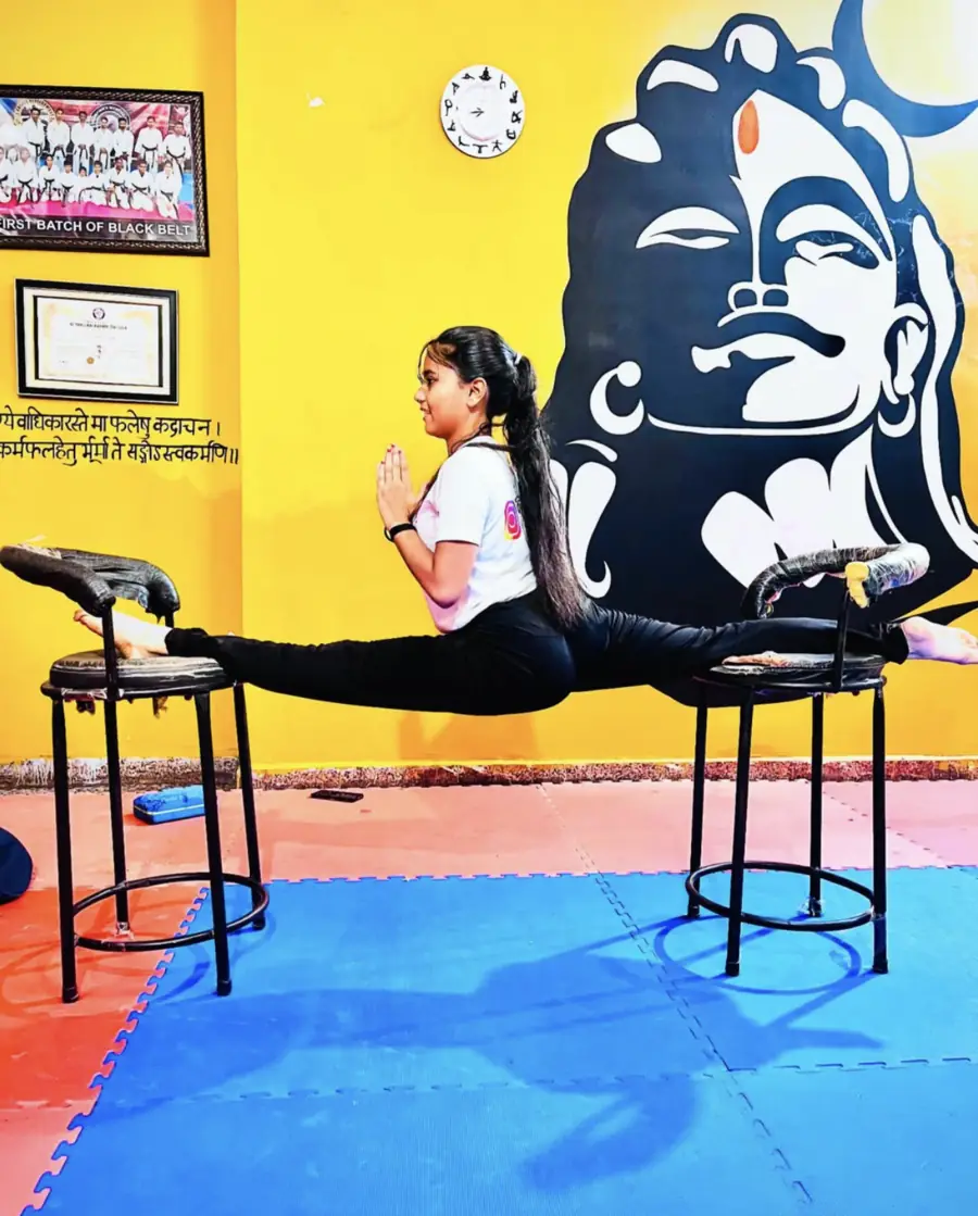 Student in elevated splits pose