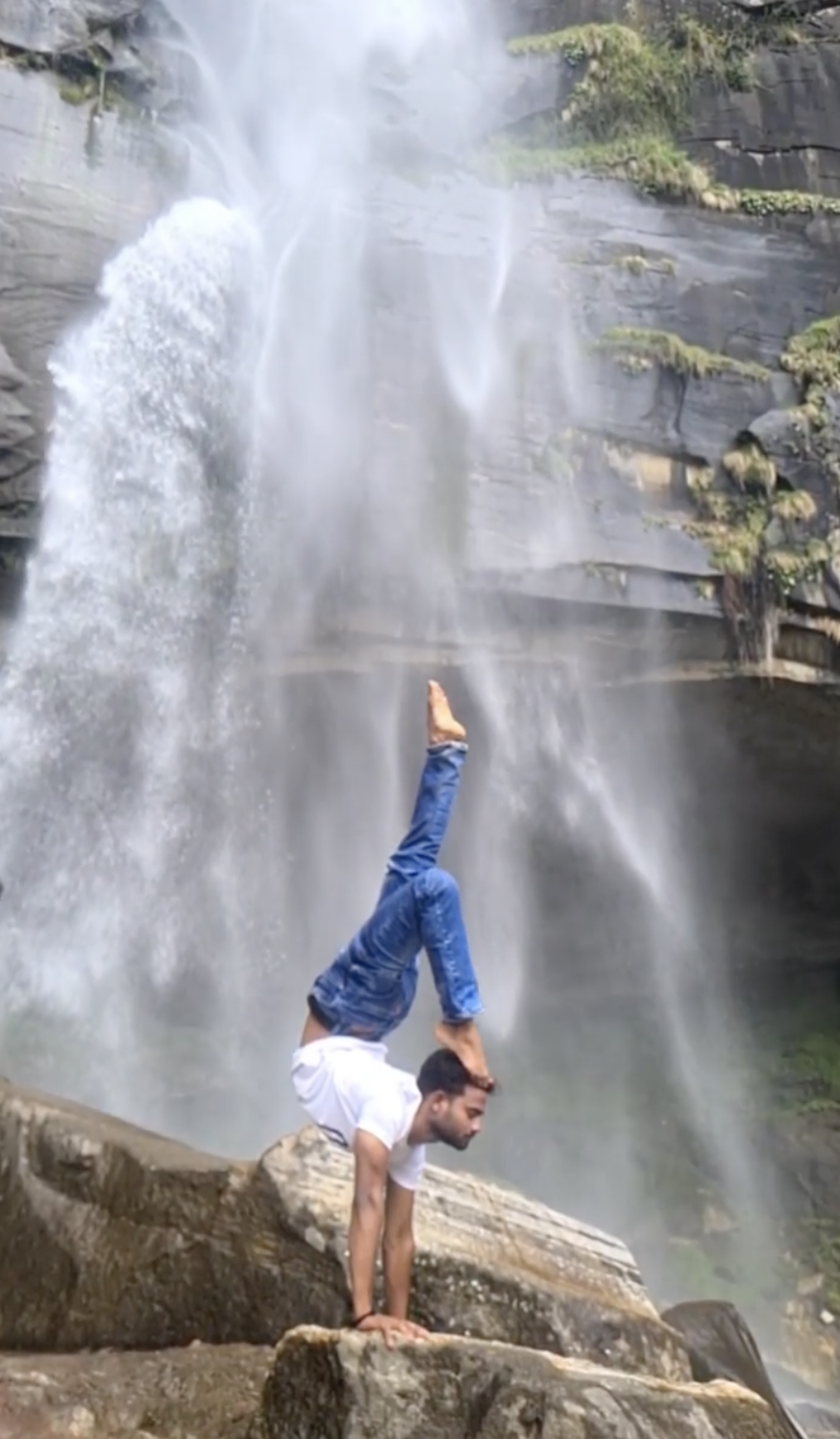 Guruji handstand under a Himalayan waterfall
